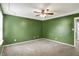 Bedroom featuring neutral carpet and is complemented by green painted walls at 5369 Red River Ct, Indianapolis, IN 46221