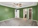 Bedroom with a fan, walk-in closet and is complemented by green painted walls at 5369 Red River Ct, Indianapolis, IN 46221