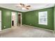Bedroom offering ample space, a window and complemented by green painted walls at 5369 Red River Ct, Indianapolis, IN 46221
