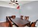 Dining room with wood floors, modern ceiling fan, a large window, and a wall mounted television at 5369 Red River Ct, Indianapolis, IN 46221