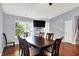 Dining room with wood floors, modern ceiling fan, a large window, and a wall mounted television at 5369 Red River Ct, Indianapolis, IN 46221