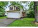 Charming two-story home with red shutters, attached two car garage, and a well maintained lawn at 5369 Red River Ct, Indianapolis, IN 46221