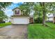 Charming two-story home with red shutters, attached two car garage, and a well maintained lawn at 5369 Red River Ct, Indianapolis, IN 46221