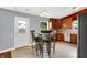 View of kitchen with stainless steel appliances, table and 4 chairs, and exterior door at 5369 Red River Ct, Indianapolis, IN 46221
