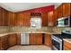 Kitchen with stainless steel appliances, tile flooring, and dark wood cabinets at 5369 Red River Ct, Indianapolis, IN 46221