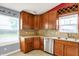 Kitchen view showcasing wood cabinetry, stainless steel dishwasher, and matching countertops at 5369 Red River Ct, Indianapolis, IN 46221