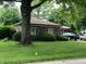 Well-maintained brick home featuring a lush, green lawn and mature trees providing ample shade at 539 Queenswood Dr, Indianapolis, IN 46217