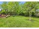 Spacious backyard featuring a brick outdoor fireplace and lush green lawn, perfect for entertaining at 5419 Cayman Dr, Carmel, IN 46033