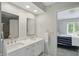 Bright bathroom with double sink vanity, quartz countertops, and modern faucets at 5419 Cayman Dr, Carmel, IN 46033