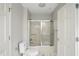 Well-lit bathroom features a shower and tub combination with sleek glass doors at 5419 Cayman Dr, Carmel, IN 46033