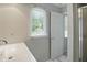 Bathroom sink and shower next to a sunny window at 5419 Cayman Dr, Carmel, IN 46033