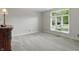 Cozy bedroom with gray carpet, natural light, and neutral walls with dark wood accents at 5419 Cayman Dr, Carmel, IN 46033
