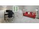 Bedroom with neutral carpet, a desk area, and a comfortable red couch with patterned pillows at 5419 Cayman Dr, Carmel, IN 46033
