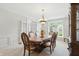 Formal dining room with light gray carpet, crown moulding, chandelier, and furniture with ornate detail at 5419 Cayman Dr, Carmel, IN 46033