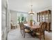 Formal dining room with light gray carpet, chandelier, furniture with ornate detail, and large windows at 5419 Cayman Dr, Carmel, IN 46033