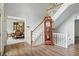 Grand foyer with hardwood floors, white trim, wood staircase, and antique grandfather clock at 5419 Cayman Dr, Carmel, IN 46033
