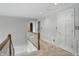 Upstairs hallway has paneled walls and carpeted floors that lead to secondary rooms at 5419 Cayman Dr, Carmel, IN 46033