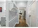 Hallway view into the kitchen and laundry area with white cabinets at 5419 Cayman Dr, Carmel, IN 46033