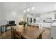 Bright, open kitchen with island, stainless appliances, wooden table, and an abundance of natural light at 5419 Cayman Dr, Carmel, IN 46033