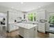 Kitchen featuring white cabinets, quartz countertops, stainless appliances, and lots of natural light at 5419 Cayman Dr, Carmel, IN 46033