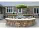 A brick koi pond in a backyard features a small fountain and multiple statues for decor at 5419 Cayman Dr, Carmel, IN 46033