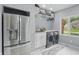 Bright laundry room with new appliances, cabinets, countertop, and a view to the yard at 5419 Cayman Dr, Carmel, IN 46033