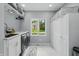 Bright laundry room with new appliances, cabinets, countertop, and a view to the yard at 5419 Cayman Dr, Carmel, IN 46033