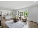 Elegant living room featuring natural light from large windows and view into updated kitchen at 5419 Cayman Dr, Carmel, IN 46033