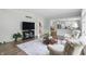 Inviting living room featuring neutral decor, hardwood floors, and an open view of the updated kitchen at 5419 Cayman Dr, Carmel, IN 46033