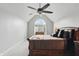 Comfortable primary bedroom has a ceiling fan, and beautiful light from the arched window at 5419 Cayman Dr, Carmel, IN 46033