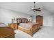 Primary bedroom with elegant wooden furniture, vaulted ceilings, ceiling fan, and a large arched window at 5419 Cayman Dr, Carmel, IN 46033