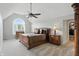 The primary bedroom is spacious and bright with a large window, vaulted ceiling, and ceiling fan at 5419 Cayman Dr, Carmel, IN 46033