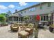 Back patio features wicker furniture, outdoor dining set, potted flowers, and a tranquil koi pond at 5419 Cayman Dr, Carmel, IN 46033