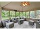 Relaxing sunroom with comfortable patio furniture, ceiling fan, and picturesque views at 5419 Cayman Dr, Carmel, IN 46033