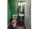 Updated half-bathroom featuring a pedestal sink and wood-look flooring at 5515 Lunsford Dr, Indianapolis, IN 46237