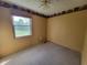 A cozy bedroom with neutral colored walls and carpet, as well as natural light from a window at 5515 Lunsford Dr, Indianapolis, IN 46237