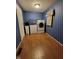 Functional laundry room with blue walls, wood floor, and modern appliances at 5515 Lunsford Dr, Indianapolis, IN 46237
