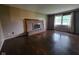 Cozy living room with a brick fireplace, hardwood floors, and natural light at 5515 Lunsford Dr, Indianapolis, IN 46237