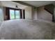 Spacious living room with plush carpeting, a ceiling fan, and glass patio doors at 5515 Lunsford Dr, Indianapolis, IN 46237