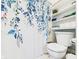 The bathroom has a toilet next to white shelves and a blue floral shower curtain at 5542 N Olivia Dr, Alexandria, IN 46001