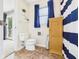 Small bathroom with toilet, small cabinet, and a view of a sliding glass door to the exterior at 5542 N Olivia Dr, Alexandria, IN 46001