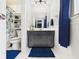 This bathroom features a blue vanity and a shower with blue floral shower curtain at 5542 N Olivia Dr, Alexandria, IN 46001
