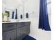 The bathroom features a vanity with a blue rug and a blue shower curtain at 5542 N Olivia Dr, Alexandria, IN 46001