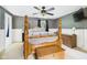 Bedroom featuring a four-poster bed, dresser, and neutral color scheme at 5542 N Olivia Dr, Alexandria, IN 46001