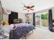 This bedroom has a ceiling fan, sliding glass door, an aquarium, and carpet flooring at 5542 N Olivia Dr, Alexandria, IN 46001