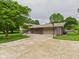 Lovely home with a long driveway and a basketball hoop, framed by lush greenery and mature trees at 5542 N Olivia Dr, Alexandria, IN 46001