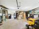 Spacious garage with overhead door, yard equipment, workbench, and lots of storage at 5542 N Olivia Dr, Alexandria, IN 46001