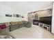 Spacious living room featuring a striking brick wall with fireplace and comfortable seating arrangement at 5542 N Olivia Dr, Alexandria, IN 46001