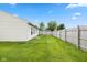 Backyard features green grass and a wooden fence at 560 Tracy Ln, Brownsburg, IN 46112