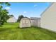 Backyard featuring shed, green grass, and wooden fence at 560 Tracy Ln, Brownsburg, IN 46112